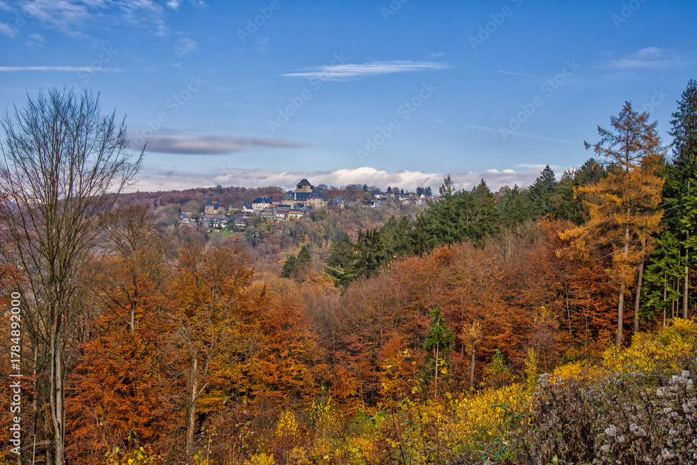 Fototapeta premium a beautiful hiking area in Solingen with a great view of the autumnal forest under blue skies