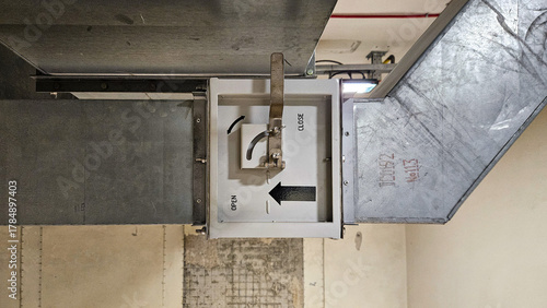 Obraz na płótnie Close up of metallic air duct with open and close damper control in industrial v