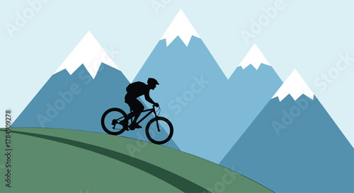 Dynamic silhouette of a mountain biker conquering a scenic trail against a backdrop of majestic snow-capped peaks