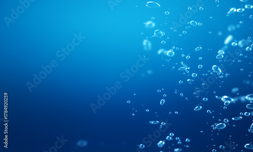 Deep blue ocean background with light rays, air bubbles, and a water drop texture