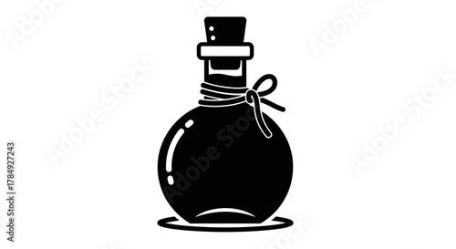 a black bottle with cork tied by string standing upright