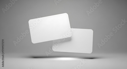 Two blank white rounded rectangle cards floating in the air with soft shadows, isolated on grey background mockup background