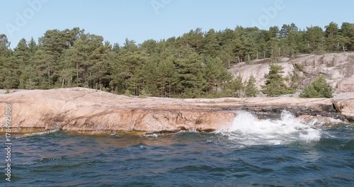 Aerial view of waves crashing on rocky seashore at Pirttisaari nature reserve,in sunny summer weather, Pirttisaari, Porvoo, Finland.