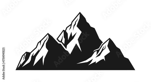 a majestic mountain peak towering over smaller peaks under clear sky