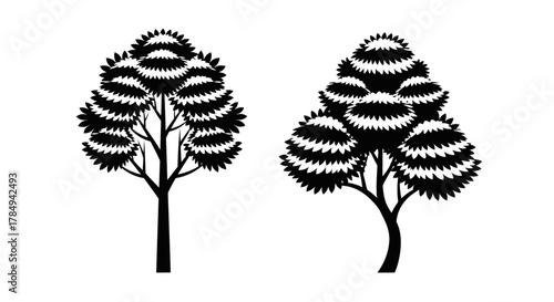 two trees standing side by side with intricate leaf patterns