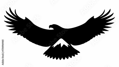 Majestic eagle soars high in silhouette, wings spread wide, a symbol of freedom and strength