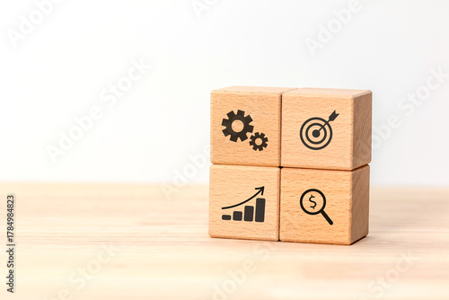 Four wooden cubes  showing business icons Concept of business process, analysis, finance, and goal achievement