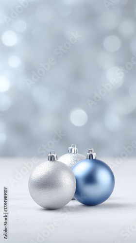 Peaceful blue and silver christmas ornament baubles create festive decoration for winter holiday. calm, elegant celebration with soft shiny bokeh background