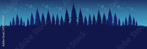 Panoramic winter background with a blue silhouette pine forest and falling snowflakes perfect for a Christmas header.