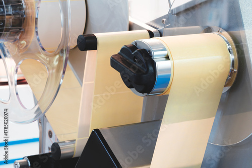 Fragment of the conveyor of sticking labeling machine. Abstract industrial background.