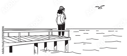 Female figure standing on a wooden pier, wearing a knit hat, gazing at a seagull flying over the ocean waves.