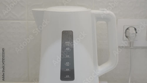 White Electric Kettle Boiling Water, Preparing Tea for a Relaxing Break.