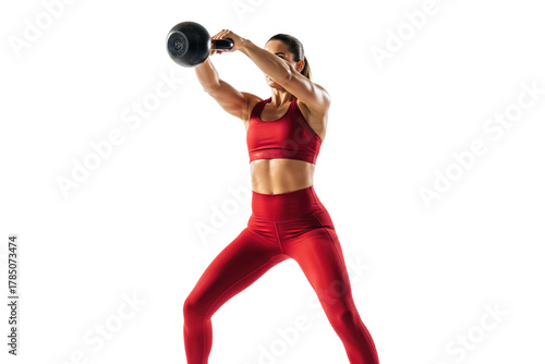 Fit woman in red sportswear performing a kettlebell swing