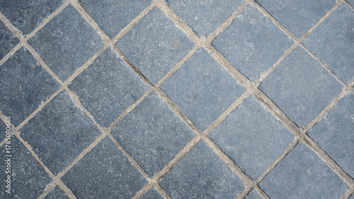 Fototapeta Naklejka Na Ścianę i Meble -  Stone wall with old bricks in the city. Gray stone block surface.