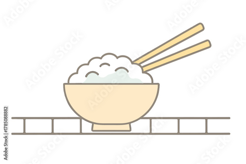 Steamed white rice in bowl with chopsticks ready for eating