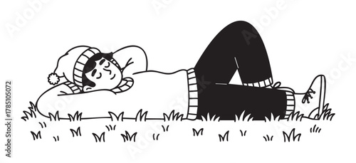 Young male wearing a sweater and beanie relaxing on grass with eyes closed and hands behind head, showcasing a peaceful outdoor moment.
