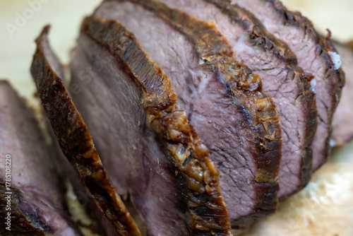 Canvas Print Close-up of delicious, tender sliced roast beef on a wooden cutting board