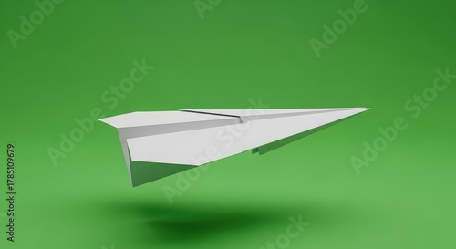 White paper airplane soaring through bright green space, symbolizing innovation and travel