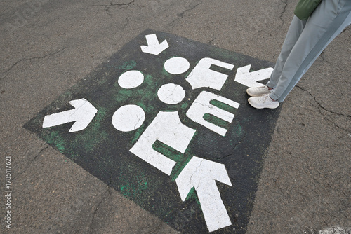 Person standing by unusual signage.