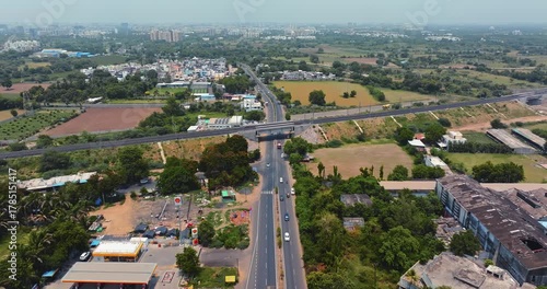 Wallpaper Mural Aerial view of a modern highway interchange in Gujarat, India, showcasing multiple flyovers and well-planned road infrastructure. The cloverleaf junction is surrounded by green fields. Torontodigital.ca