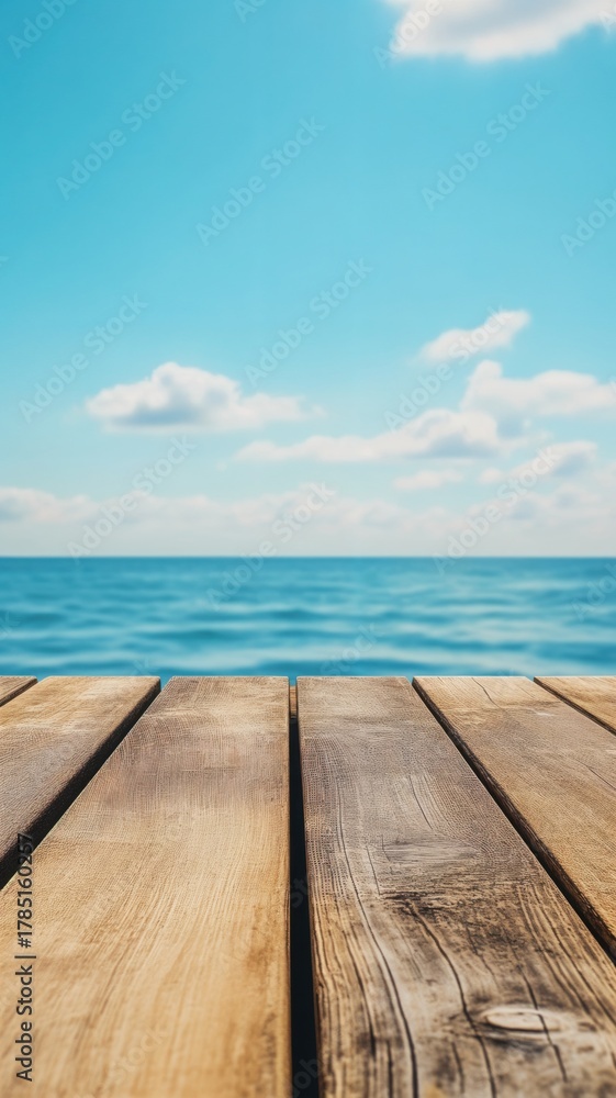 Fototapeta premium Wooden dock overlooking tranquil blue sea and sky, idyllic vacation scene