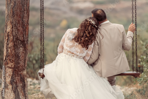 Wedding emwedding, wedding couple, romantic, relationship, couple, romance, together, swing, love, in love, husband, groom, embracing, wedding day, autumn, joy, beautiful, bridbracing in love on swing