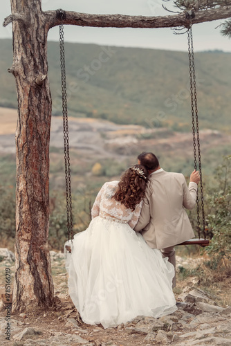 Wedding emwedding, wedding couple, romantic, relationship, couple, romance, together, swing, love, in love, husband, groom, embracing, wedding day, autumn, joy, beautiful, bridbracing in love on swing
