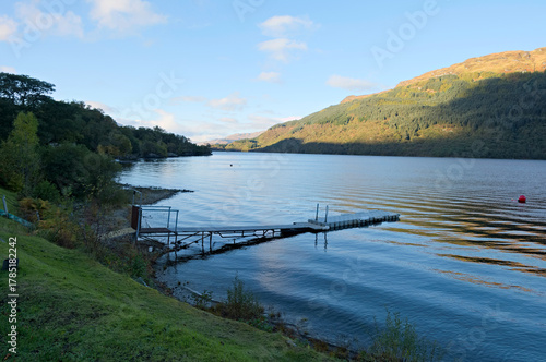 Evening light on the hillside from a little jetty near Firkin Point, a viewpoint off the A82 on the west shore of Loch Lomond, OS map ref NN 338 007, Argyll and Bute, Scotland.