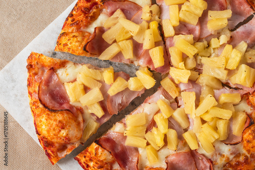 Hawaiian pizza topped with sliced ham and chunks of sweet pineapple.