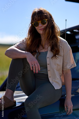 Ginger woman with sunglasses on Safari