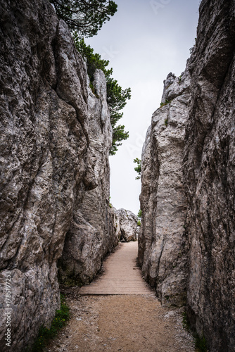 Pass through rocks on hiking trail from the summit of the Kehlstein mountain, above the Eagle's Nest building in in Berchtesgaden, Germany.