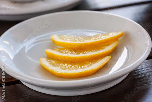 Lemon wedges on a white plate.