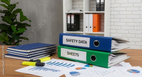 Organized office workspace with binders and documents on table  