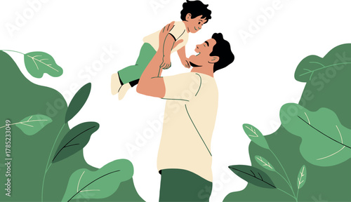 A father happily lifts his young child up in the air amidst greenery.