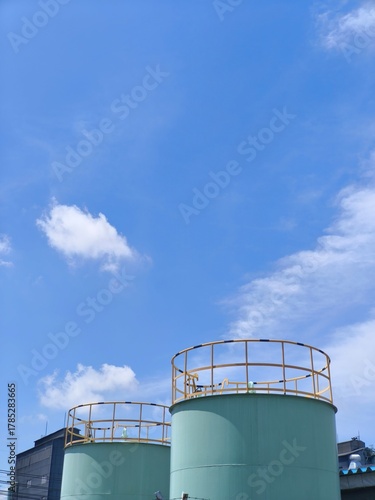 Large Industrial Storage Tank under Blue Sky
