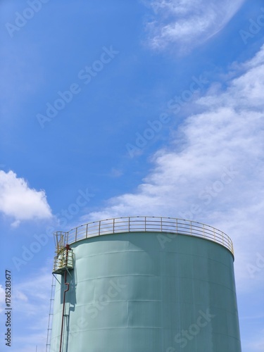 Large Industrial Storage Tank under Blue Sky