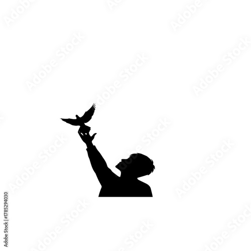 Silhouette of a person releasing a dove into the sky.