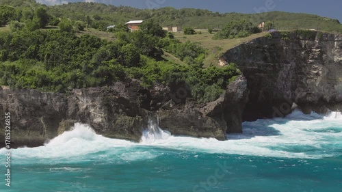 Waves crashing against dramatic rocky cliffs on Nusa Penida island, Bali, Indonesia