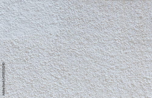 Beautiful view of popcorn sprayed ceiling of street wall of white building.