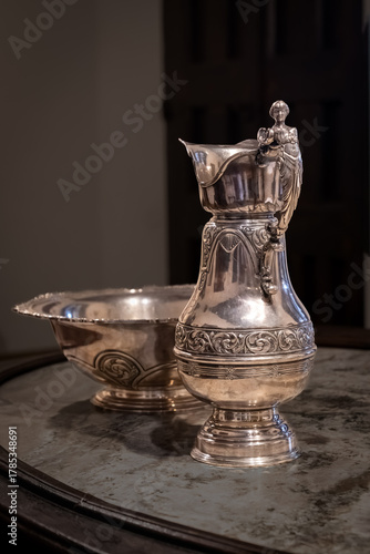 Antique silver pitcher and basin with ornamental engravings