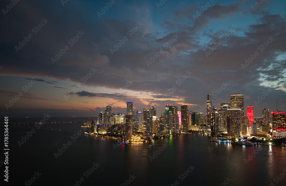Fototapeta premium Famous landmarks of Miami Brickell from above at night. Drone view of the Brickell in Miami city. Business in Brickell district. Biscayne Bay Florida iconic urban coastline in daylight.
