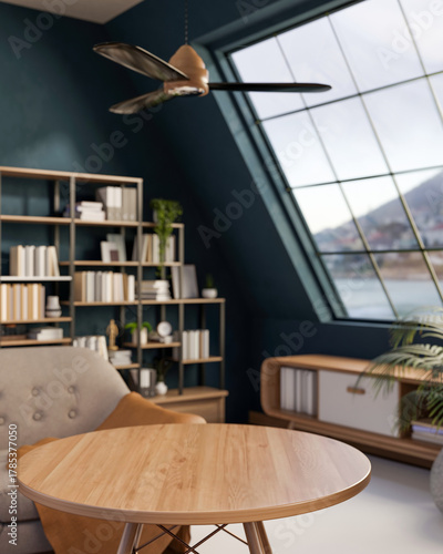 Fototapeta Naklejka Na Ścianę i Meble -  Empty round wood table and chair with bookshelf and roof window with ceiling fan in green attic room