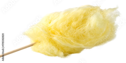 Close-up of fluffy yellow cotton candy on a wooden stick against a black background candy floss isolated on a transparent background