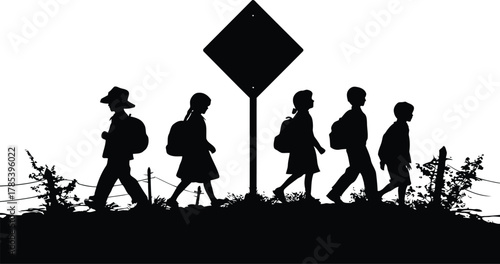 Silhouette of children walking on a path near a school crossing sign