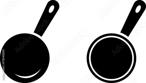 Two black silhouettes of cooking pans with handles