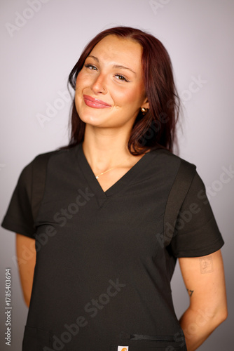 Pretty young woman wearing scrubs that can be used as a nurse or in a beauty salon. 