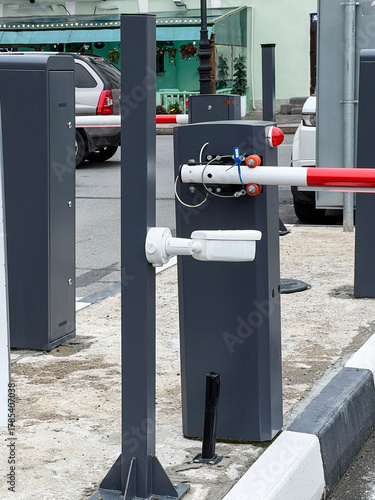Modern traffic barrier stands at entrance to parking structure in urban area