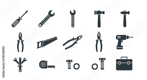 A collection of various tools, rendered in solid dark shapes against a bright white background. Includes wrenches, hammers, saws, pliers, a drill, and a toolbox