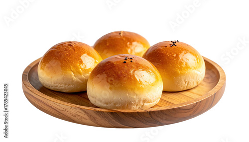Golden buns on wood platter. Simple, appetizing presentation