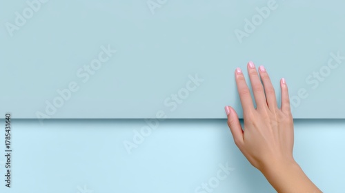 Close up of woman's hand gently touching textured wall exploring tactile sensation and connection.